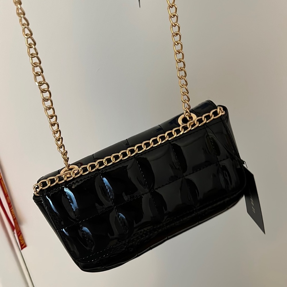 small black and gold hand bag